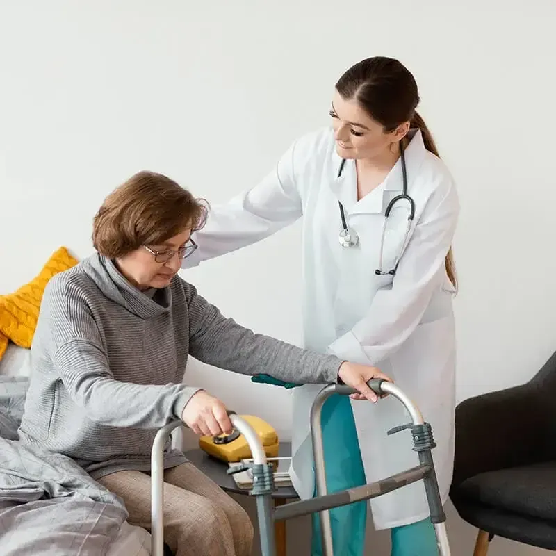 Caregiver supporting a resident with a walker